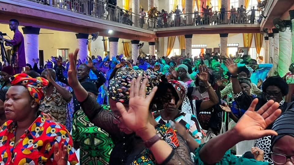 A congregation with hands raised during worship