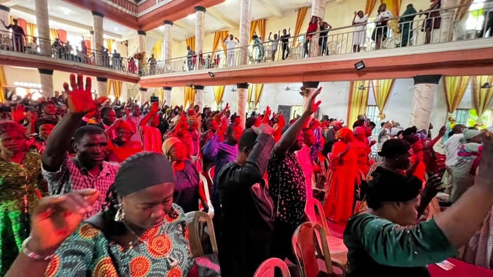 People with hands raised in worship